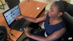 Design engineering graduate Youma Fall shows pictures of baskets, the inspiration for another app she might later pursue to help women sell local products from her PayDunya office in Dakar, Senegal, Sept. 7, 2016.