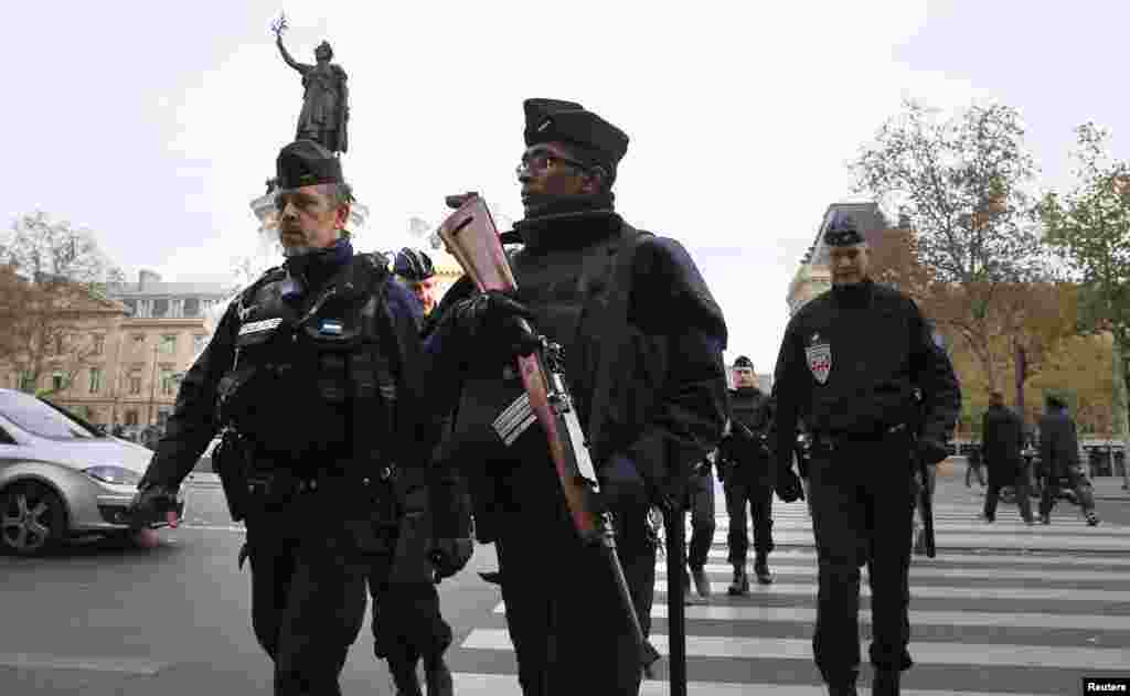 Police patrol in Place de la Republique Saturday after a series of deadly attacks the previous day in Paris, Nov. 15, 2015. 