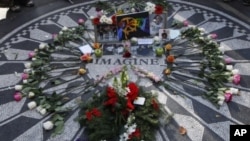 Mementos and flowers left by fans lay around the Imagine mosaic in the Strawberry Fields section of Central Park on the 30th anniversary of the death of former Beatle John Lennon in New York, December 8, 2010.