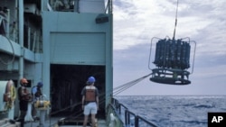 Scientists prepare to sample the ocean on the RV Knorr in August 1997 in the Sargasso Sea.