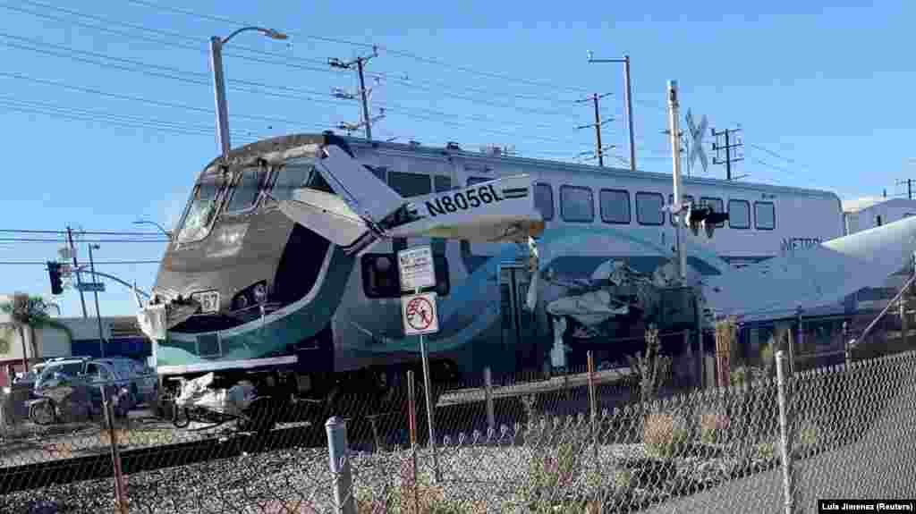 A train hits an aircraft that crashed on railway tracks in Los Angeles, California, U.S. January 9, 2022 in this screen grab from a social media video obtained by Reuters.