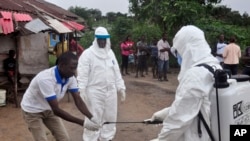 Des travailleurs de la santé chargés de lutter contre le virus à Ebola à Monrovia, au Liberia (AP Photo/ Abbas Dulleh)