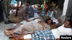 Wounded supporters of deposed Egyptian president Mohamed Mursi wait for treatment at a field hospital in Cairo, July 8, 2013.