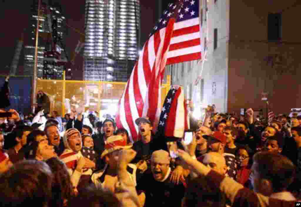 With the new One World Trade Center building in the background, second left, a large, jubilant crowd reacts to the news of Osama bin Laden's death at the corner of Church and Vesey Streets, adjacent to ground zero, during the early morning hours of Tuesda