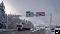 A truck passes the Norwegian border towards Sweden, Feb. 8 2019. Norway's hard border with the European Union is equipped with cameras, license-plate recognition systems and barriers directing traffic to Customs officers. 
