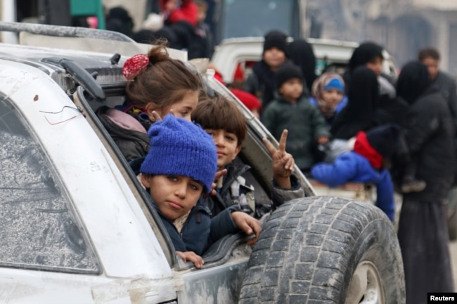 FILE - Children sit in a car as they wait to be evacuated from a rebel-held sector of eastern Aleppo, Syria, Dec. 16, 2016. According to the U.N., nearly half of all migrants and refugees are children, many of whom are unaccompanied and, therefore, especially vulnerable.
