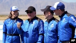 William Shatner, center right, speaks as Audrey Powers, left, Chris Boshuizen, center right, and Glen de Vries all look on during a media availability at the Blue Origin spaceport near Van Horn, Texas, Wednesday, Oct. 13, 2021. (AP Photo/LM Otero)
