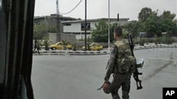 In this image taken on a mobile phone, a Syrian soldier patrols streets in Damascus, Syria, May 8, 2011