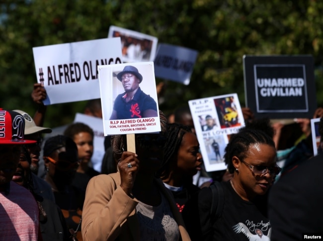 FILE - Demonstrators hold a march and rally to protest the fatal police shooting of Ugandan immigrant Alfred Olango in El Cajon, California, Oct. 1, 2016.