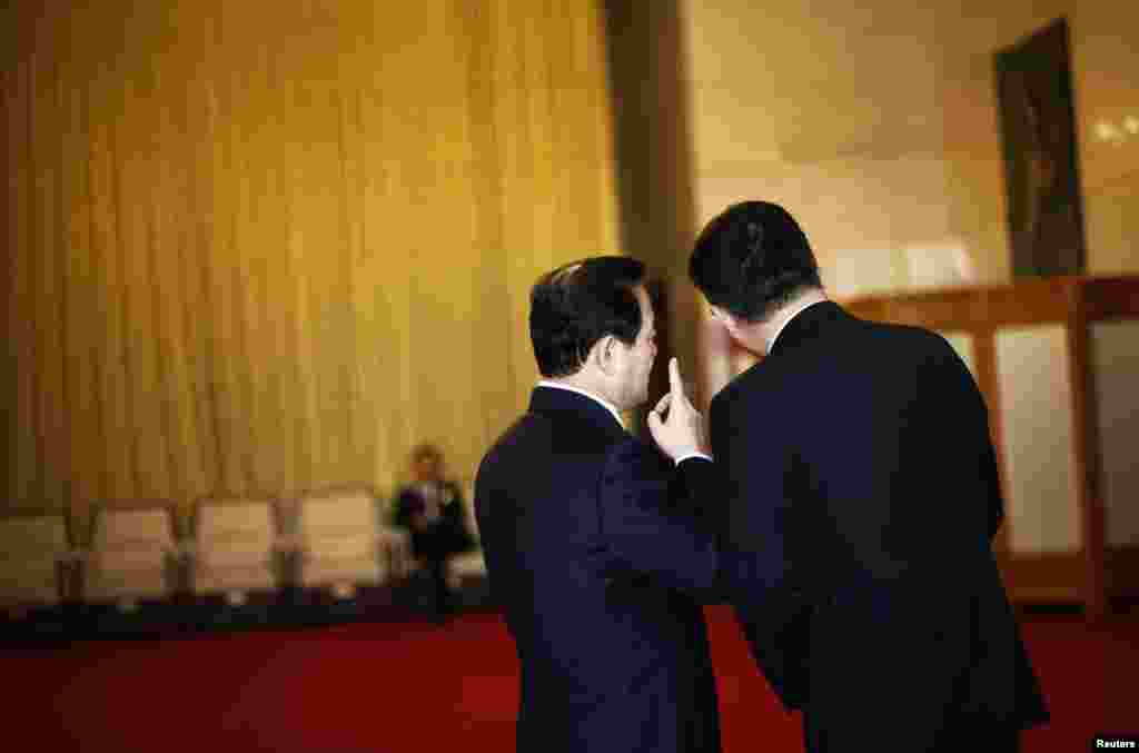 Delegates chat outside of the Guangxi room before a meeting at the Great Hall of the People, the venue of the 18th National Congress of the Communist Party of China in Beijing, November 8, 2012. 