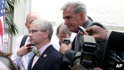 House Majority Leader Kevin McCarthy of California, right, and Rep. Patrick McHenry, R-NC, left, race past reporters on Capitol Hill, Washington, Sept. 25, 2015.