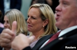 Acting Immigration and Customs Enforcement Director Thomas Homan gives a thumbs-up as he and Homeland Security Secretary Kirstjen Nielsen listen during an immigration event hosted by President Donald Trump at the White House in Washington, June 22, 2018.