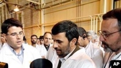 Iranian President Mahmoud Ahmadinejad listens to a technician during his visit of the Natanz Uranium Enrichment Facility, 8 Apr 2008