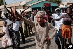 Gambians celebrate the victory of opposition coalition candidate Adama Barrow against longtime President Yahya Jammeh in the streets of Serrekunda, Gambia, Dec. 2, 2016, an upset victory.