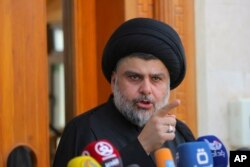 Sh'iite cleric Muqtada al-Sadr speaks during a media conference in Najaf, Iraq,160 kilometers south of Baghdad, April 30, 2016. Hundreds of Sadr's supporters protesting against the government, stormed into the heavily fortified Green Zone in Baghdad Satur