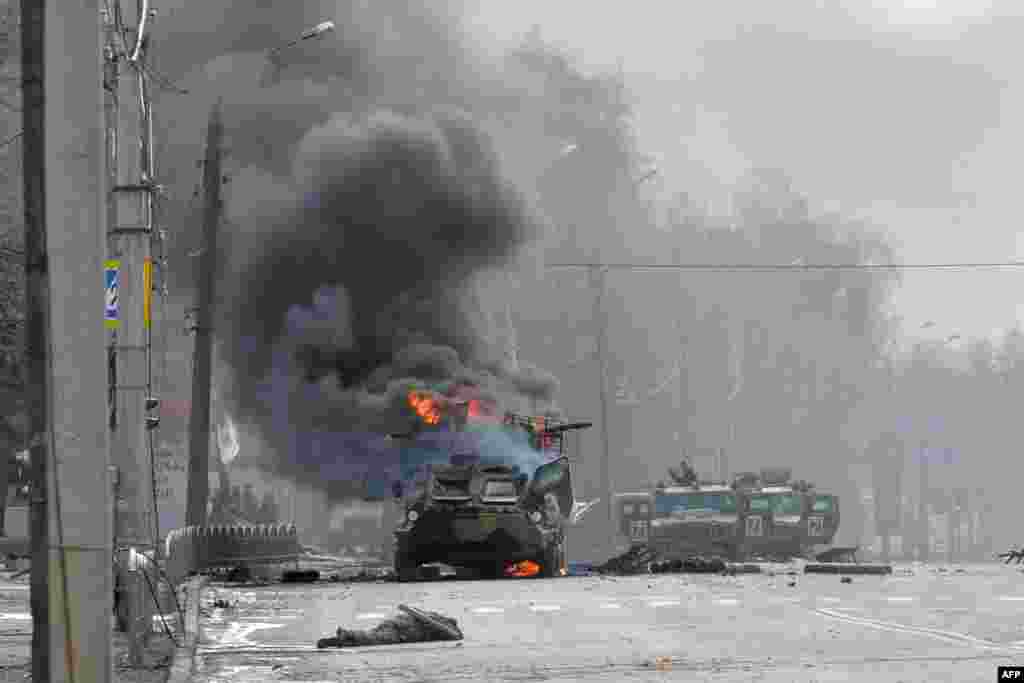 A Russian Armored personnel carrier (APC) burns next to unidentified soldier&#39;s body during a fighting with the Ukrainian armed forces in Kharkiv, Feb. 27, 2022.