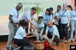 Malaysian Minister of Transport Anthony Loke, third from left, plants a tree with family members of passengers of the missing Malaysia Airlines Flight MH370 during a Day of Remembrance for MH370 event in Kuala Lumpur, March 3, 2019.