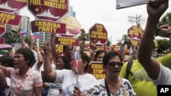 Protesters march towards the Chinese consulate during a rally in Manila's financial district of Makati, Philippines, May 11, 2012.