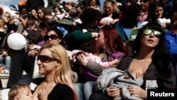 FILE - Women breastfeed babies during a mass event in Athens, Nov. 2, 2014.