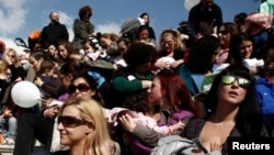 FILE - Women breastfeed babies during a mass event in Athens, Nov. 2, 2014.
