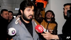 FILE - Turkish-Iranian businessman Reza Zarrab, charged in the U.S. with allegedly evading sanctions on Iran, is surrounded by reporters as he arrives at a courthouse in Istanbul, in a separate case against him, Dec. 17, 2013.