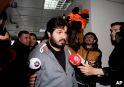 FILE - Turkish-Iranian businessman Reza Zarrab, charged in the U.S. with allegedly evading sanctions on Iran, is surrounded by reporters as he arrives at a courthouse in Istanbul, in a separate case against him, Dec. 17, 2013.