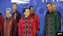 President Barack Obama stands with China's Premier Wen Jiabao, center, as they wait to take a family photo at the East Asia Summit Gala dinner in Nusa Dua, on the island of Bali, Indonesia, November 18, 2011.