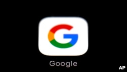 FILE - The Google app is shown on an iPad in Baltimore, March 19, 2018. Google says it will do a better job of verifying the identity of political ad buyers in the U.S., requiring them to provide a government-issued ID and other key information before allowing them to buy ads.