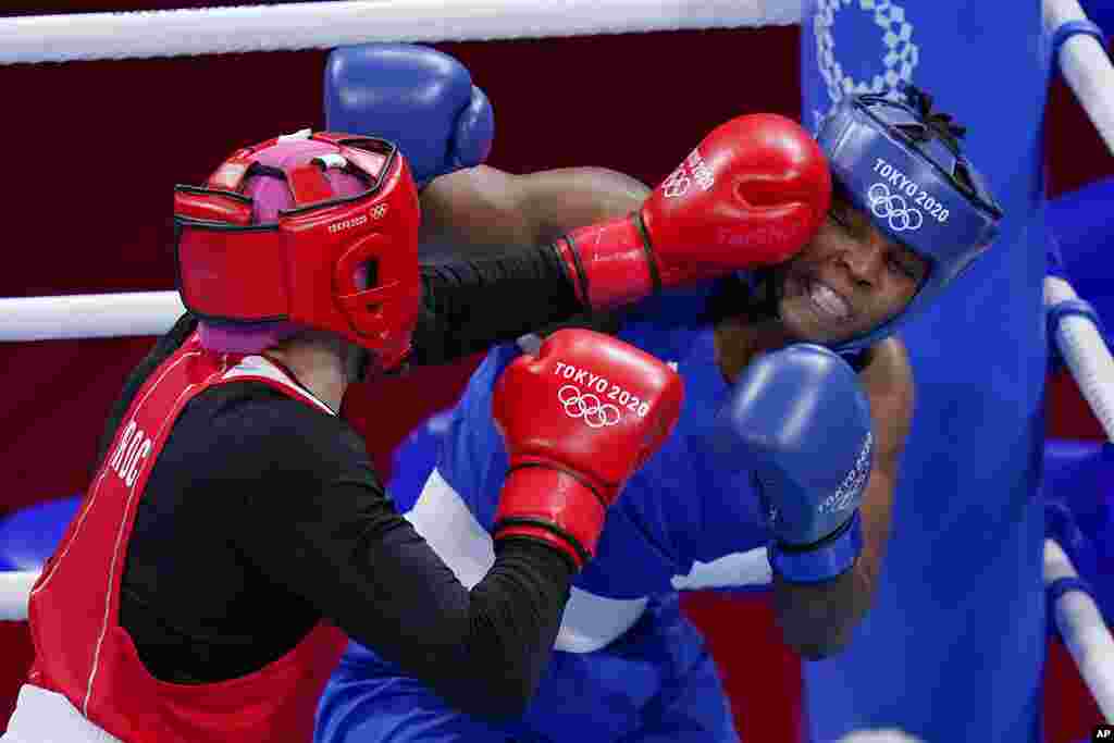 Zenfira Magomedalieva, of the Russian Olympic Committee, left, exchanges punches with Mozambique&#39;s Rady Adosinda Gramans during their women&#39;s middleweight 75-kg boxing match at the 2020 Summer Olympics, Saturday, July 31, 2021, in Tokyo, Japan. (AP Photo/Frank Franklin II)