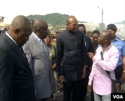 The governor of Cameroon's southwest region, Bernard Okalia Bilai (3-L), speaks to a trader while touring a burned down market in Limbe, Cameroon, April 3, 2017. (M.E. Kindzeka/VOA)