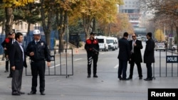 Turkish police take security measures on a road leading to Prime Minister Tayyip Erdogan's offices in Ankara, Nov. 21, 2013. 