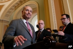 FILE - Senate Democratic Minority Leader Chuck Schumer (New York), left, pauses while speaking during a media availability on Capitol Hill, May 8, 2018, in Washington.