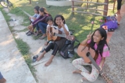 Young pupils skillfully play guitar and sing along famous hit songs, on Sept. 24, 2019, at Seametrey Children's Village, in Kandal province, Cambodia. (Rithy Odom/VOA Khmer)