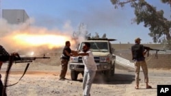 In a frame grab from a video obtained from a freelance journalist traveling with the Misarata brigade, fighters from the Islamist Misarata brigade fire toward Tripoli airport in an attempt to wrest control from a powerful rival militia, in Tripoli, Libya,