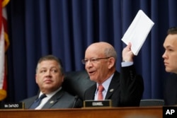 Rep. Peter DeFazio, D-Oregon, ranking member on the House Transportation Committee, holds up airline passenger rules as he questions United Airlines CEO Oscar Munoz during the committee's hearing on Capitol Hill in Washington, May 2, 2017.