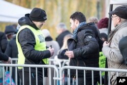 The Strasbourg's Christmas market reopens under the protection of police, who do security checks as shoppers return, in Strasbourg, France, Dec. 15, 2018. French police shot and killed the man who they believed attacked Strasbourg's Christmas market Tuesday killing four people.