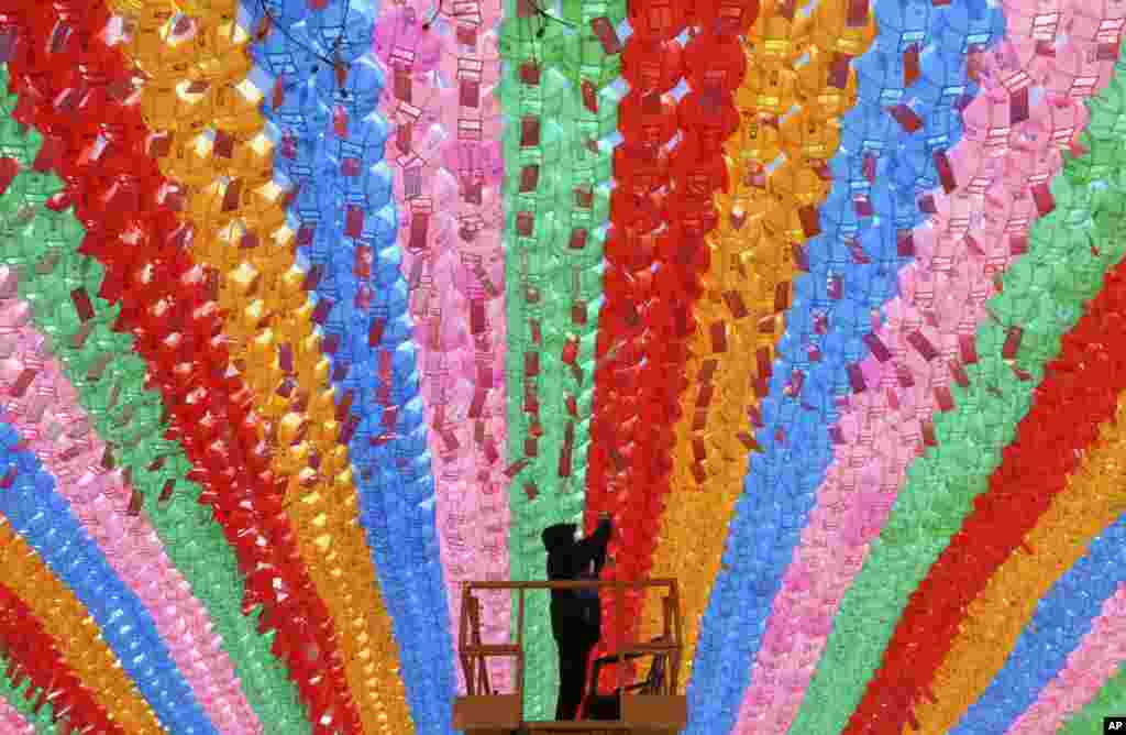 A worker attaches a name tag of a Buddhist who made a donation to a lantern for the upcoming celebration of Buddha&#39;s birthday on May 12 at the Jogye temple in Seoul, South Korea.