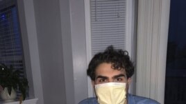 In this March 29, 2020 photo provided by Marianne Oselett, Oselett's son Carter celebrates his 21st birthday at their home in Macomb, Michigan.