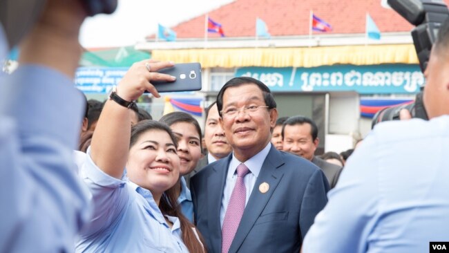 Prime Minister Hun Sen took a selfie with his supporter at the annual ceremony to mark 38 years since the fall of Khmer Rouge in 1979 at its headquarter on January 07, 2017 in Phnom Penh. (Hean Socheata/ VOA Khmer)