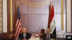 U.S. Vice President Joseph Biden, left, and Iraqi Prime Minister Nouri al-Maliki, right, hold a joint news conference in Baghdad, Iraq, Nov. 30, 2011.