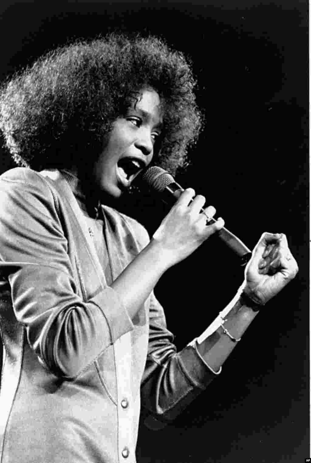 In this May 10, 1986 photo, American singer Whitney Houston sings during a benefit concert at Boston Garden. Houston died February 11, 2012, at age 48. (AP)