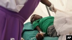 A patient suffering from HIV is taken to a local hospital in Harare, January 31, 2012. 