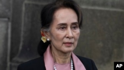 Myanmar's leader Aung San Suu Kyi leaves the International Court of Justice after the first day of three days of hearings in The Hague, Netherlands, on Dec. 10, 2019. (AP Photo/Peter Dejong, File)