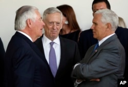 FILE - From left, Secretary of State Rex Tillerson, Defense Secretary Jim Mattis and Vice President Mike Pence talk in the Rose Garden at the White House in Washington, June 26, 2017.