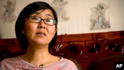 FILE - Chinese rights lawyer Wang Yu speaks during an interview in Beijing, April 18, 2015. Her 16-year-old son has disappeared in Myanmar after trying to escape to the United States, a rights campaigner involved in the plan said on Oct. 11, 2015.