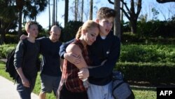 Students react following a shooting at Marjory Stoneman Douglas High School in Parkland, Florida, a city about 50 miles (80 kilometers) north of Miami, Florida, Feb. 14, 2018.