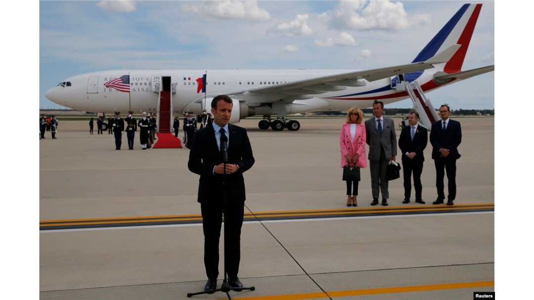 French President Emmanuel Macron speaks to the news media after arriving with his wife Brigitte Macron for their state visit to Washington at Joint Base Andrews in Maryland, April 23, 2018.