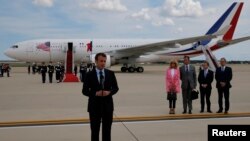 French President Emmanuel Macron speaks to the news media after arriving with his wife Brigitte Macron for their state visit to Washington at Joint Base Andrews in Maryland, April 23, 2018. 