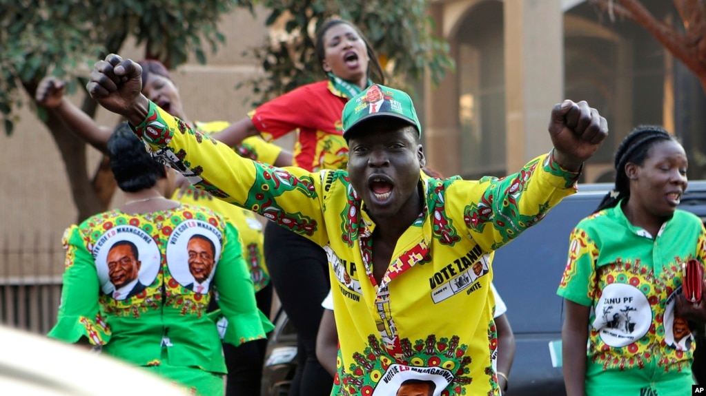 FILE:Supporters of Zimbabwean President Emmerson Mnangagwa celebrate in Harare, Friday, August, 24, 2018. Zimbabwe's constitutional court on Friday unanimously upheld Mnangagwa's narrow victory in the 2018 presidential election after the opposition alleged vote-rigging.