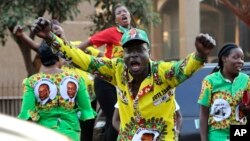 FILE: Supporters of Zimbabwean President Emmerson Mnangagwa celebrate in Harare, Friday, August, 24, 2018. Zimbabwe's constitutional court on Friday unanimously upheld Mnangagwa's narrow victory in last month's historic election after the opposition alleged vote-rigging.